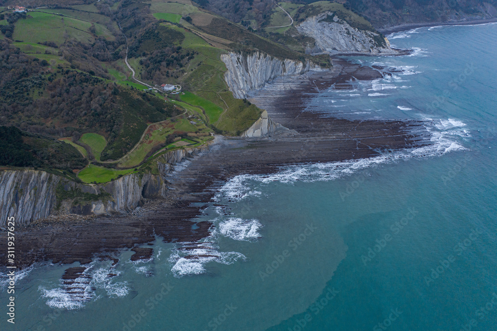 Zumaia and Deba flysch geological strata layers drone aerial view, Basque Country