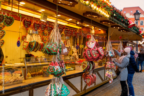 Young woman walking on Christmas market in Europe on holidays. Gingerbread shop and Christmas toys at Xmas Market © AnnKot