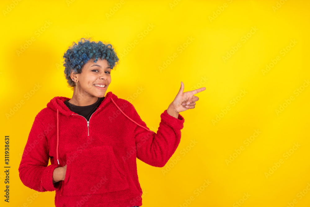 afro american woman isolated on color background pointing by hand