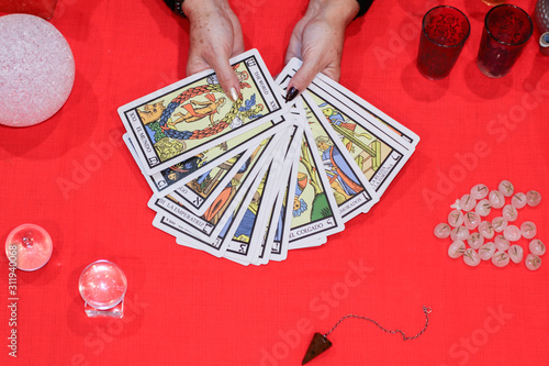 Fortune teller showing tarot cards predicting future. 