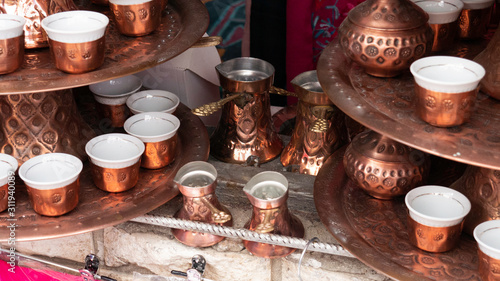 Traditional handmade souvenir - Turkish coffee pot with small copper cups.
