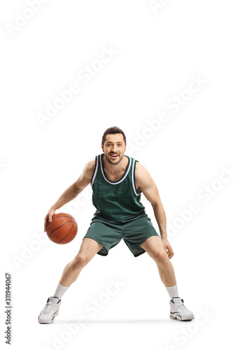 Basketball player in green jersey with ball