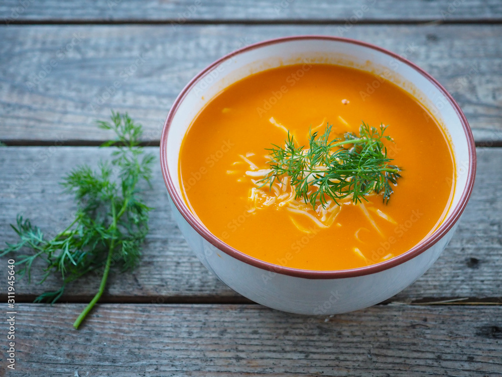 Bowl of tomato soup with grated cheese and dill Bowl of tomato soup with grated cheese and dill