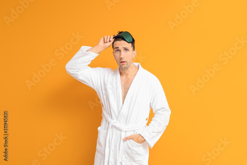 Surprised man in bathrobe a...