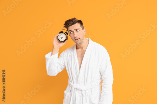 Emotional man in bathrobe a...