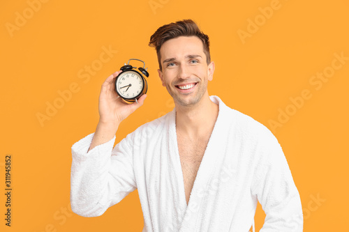 Handsome man in bathrobe an...