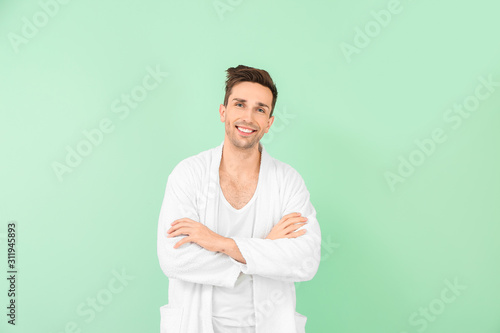 Handsome man in bathrobe on...
