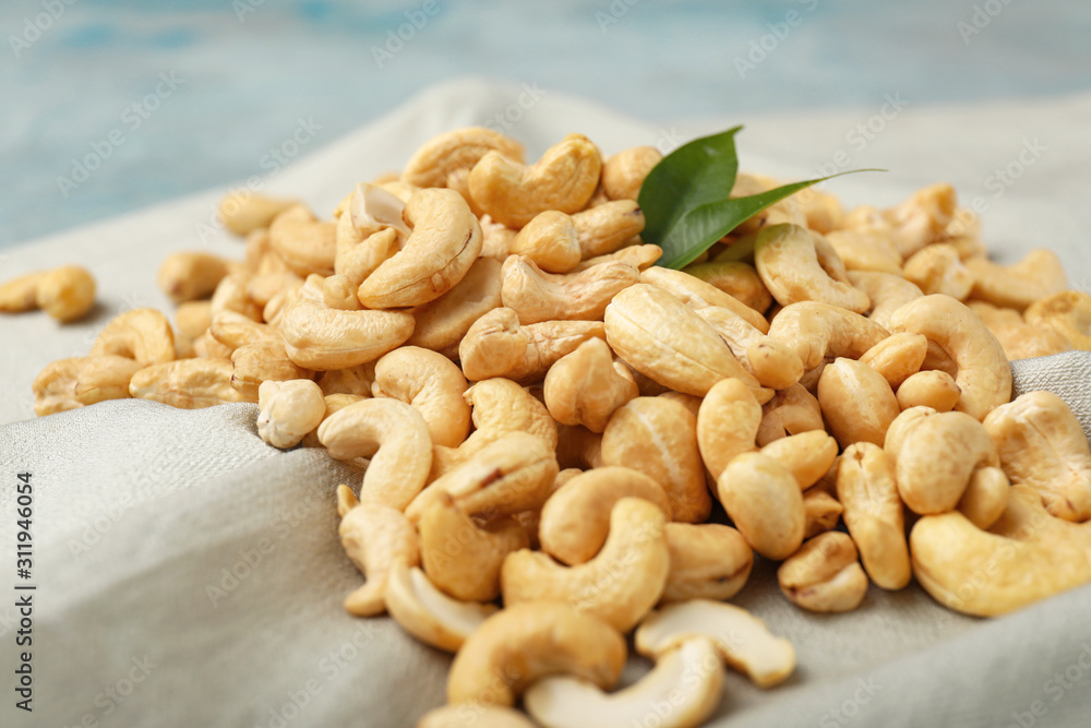 Fototapeta premium Tasty cashew nuts on table, closeup