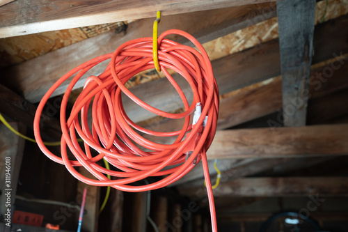 orange extension cord is hanging up and ready for your project photo