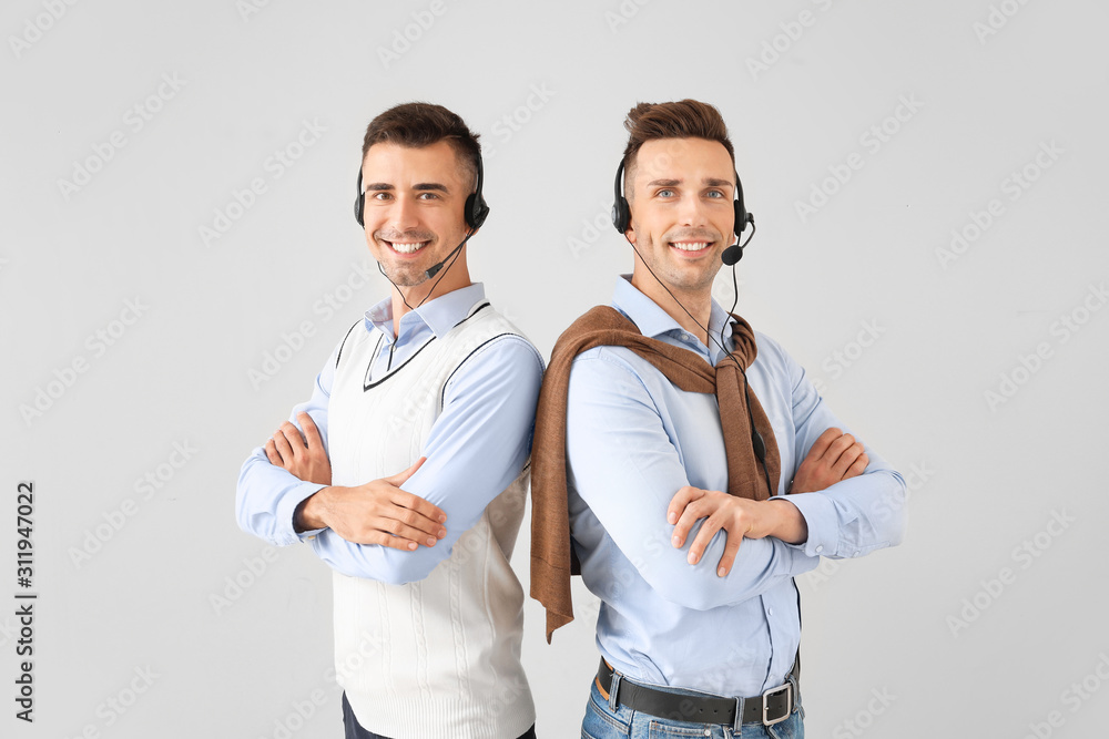 Team of technical support agents on light background Team of technical support agents on light background