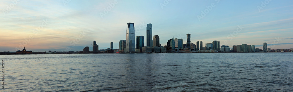 Sunset at Jersey City skyline with panoramic view from Manhattan