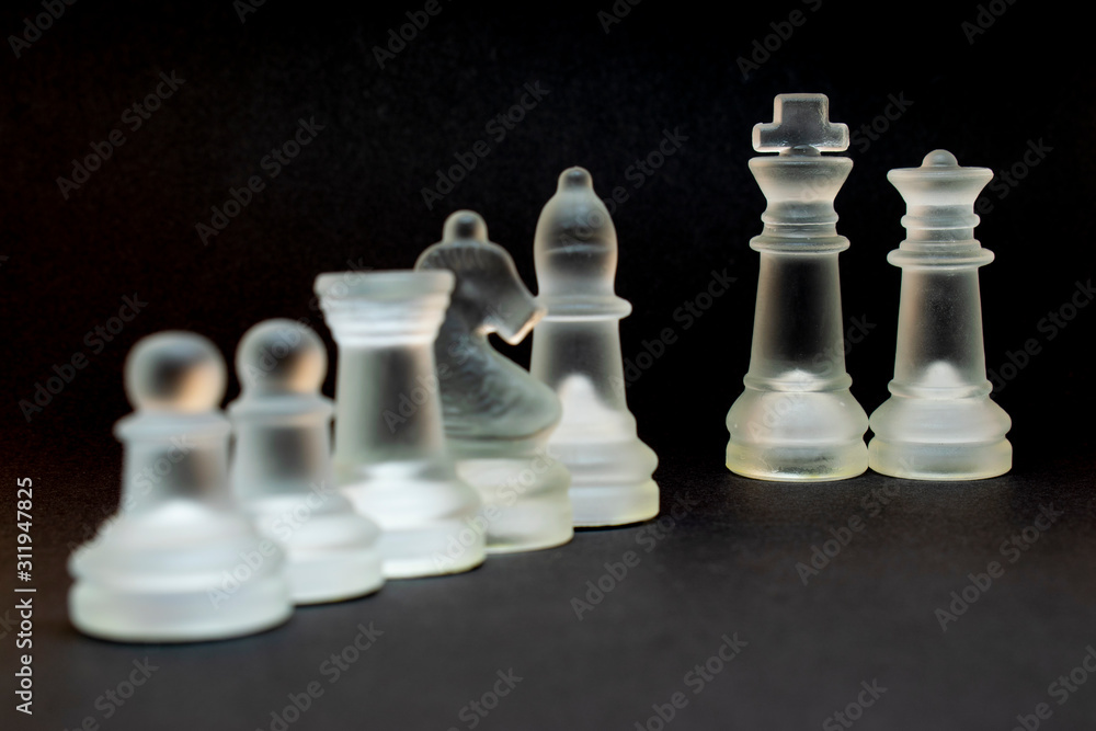 Elite glass chess. Randomly constructed pieces. Close-up on a black background. Elite glass chess. Randomly constructed pieces. Close-up on a black background.