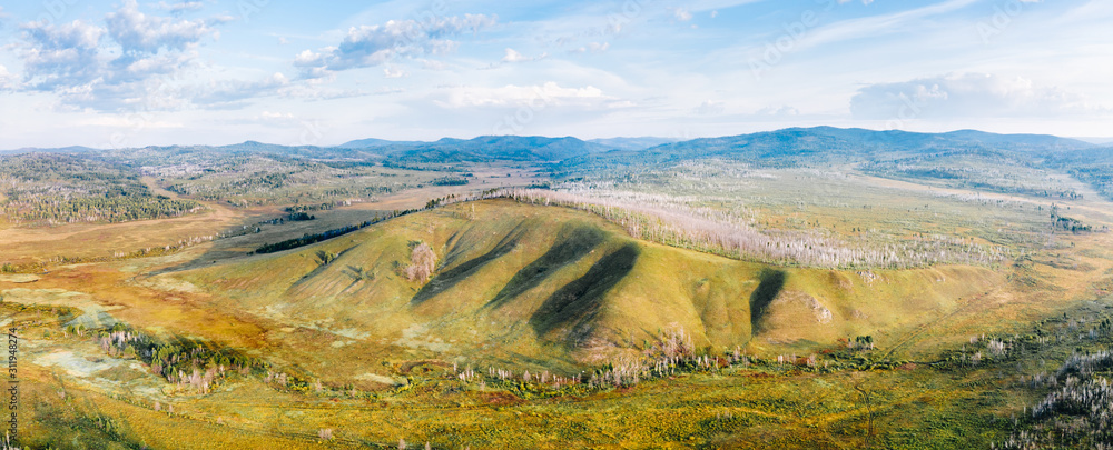 Panorama of siberian taiga in Zabaykalsky Krai, Russia with hills, swamps, and trees, high angle aerial view. Wild nature landscape in Far East, Asia