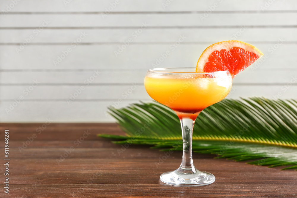 Glass of fresh citrus juice on table Glass of fresh citrus juice on table