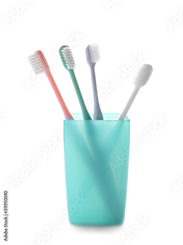 Holder with tooth brushes on white background