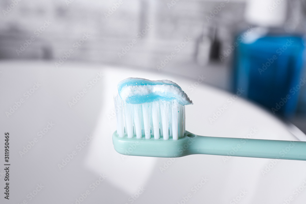 Tooth brush with paste in bathroom, closeup Tooth brush with paste in bathroom, closeup