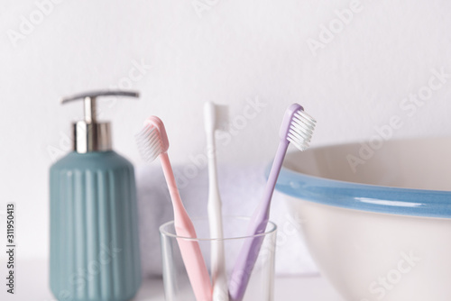 Holder with tooth brushes in bathroom