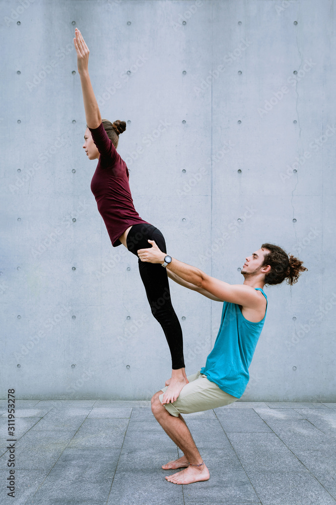 Couple practicing acro yoga outdoors. Acroyoga concept. Stock Photo