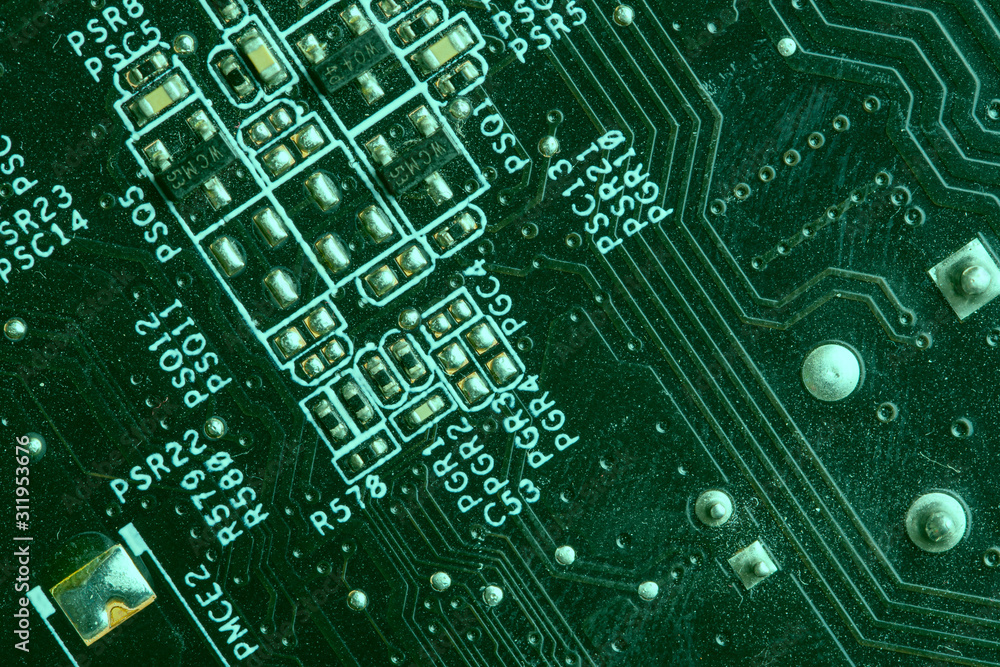 A close up macro photo of a generic technology motherboard circuit board  (pcb) light with a green flash gel on a diagonal angle Stock Photo | Adobe  Stock