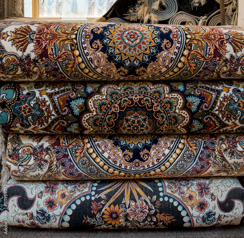 Rolled-up Persian carpets are sold in the Eastern market.
