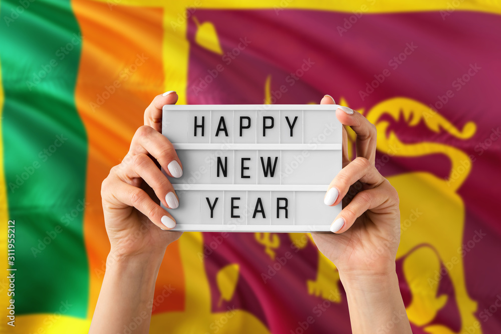 Sri Lanka New Year concept. Woman holding Happy New Year sign with ...