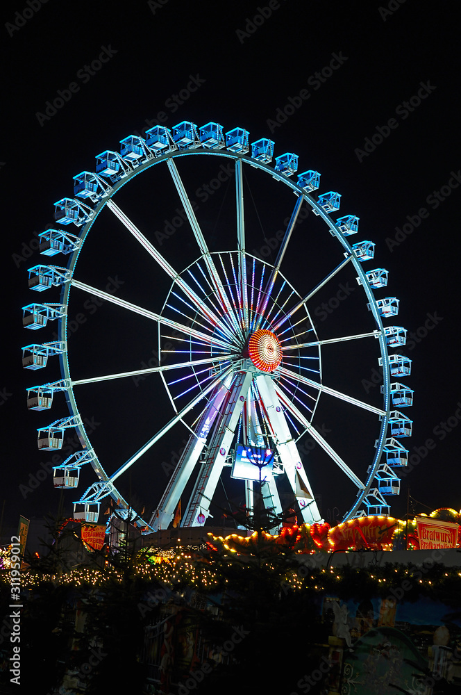 Colorful illuminated big wheel at the Christmas market in Berlin, Germany.