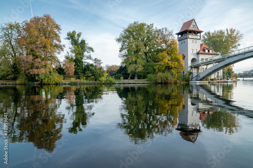 Canvas Print Reflected image of Abteibrücke with trees on the still Spree River, Treptower Pa