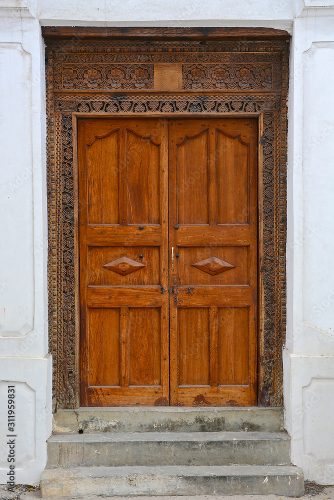 A wooden door, with traditional carvings, in Stonetown, Zanzibar. 