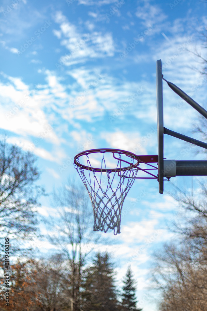 Basketball hoop in front of blue sky