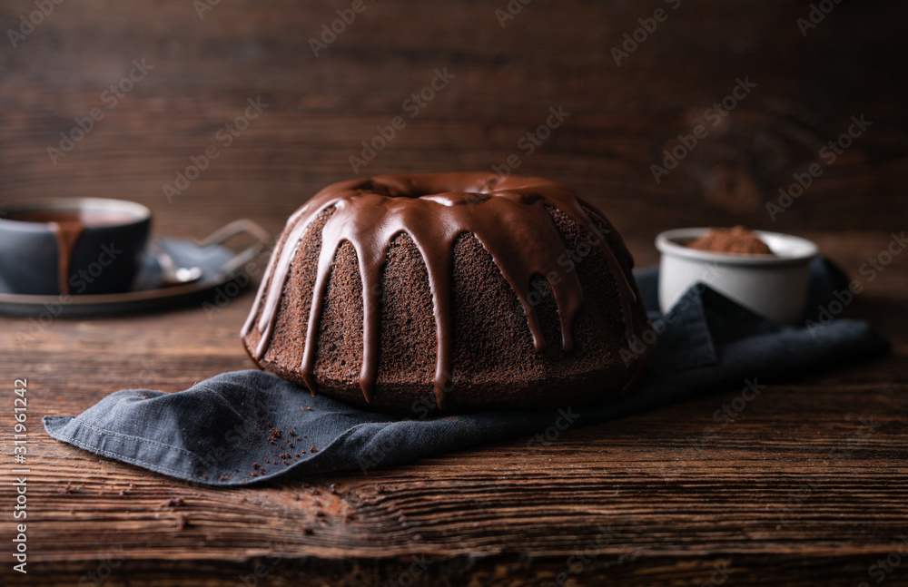 Delicious dessert, dark chocolate bundt cake topped with ganache glaze
