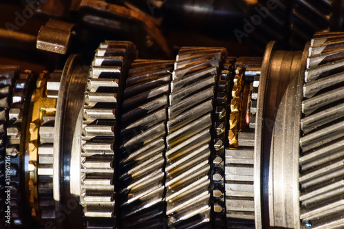 Dismantled box car transmissions. The gears on the shaft of a me photo