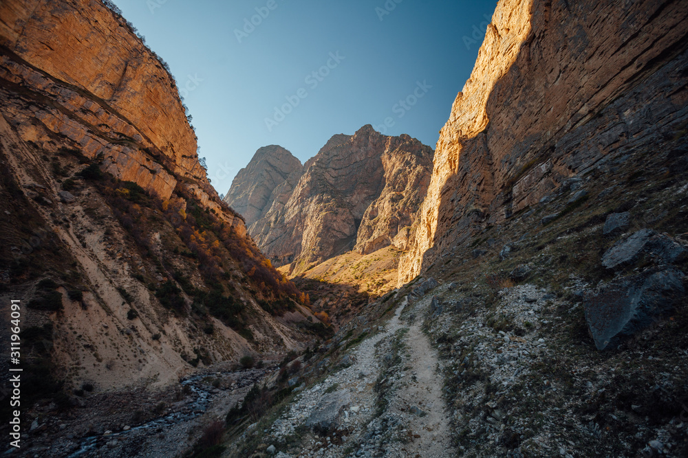 Obraz premium Large Chegem river canyon in sunny golden autumn, Republic of Kabardino-Balkaria