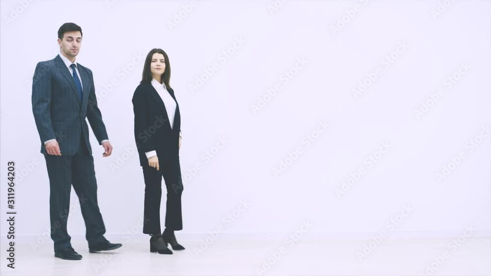 Attractive business man and woman appearing on the white background, folding their hands, nodding , showing satisfaction, smiling. Attractive business man and woman appearing on the white background, folding their hands, nodding , showing satisfaction, smiling.
