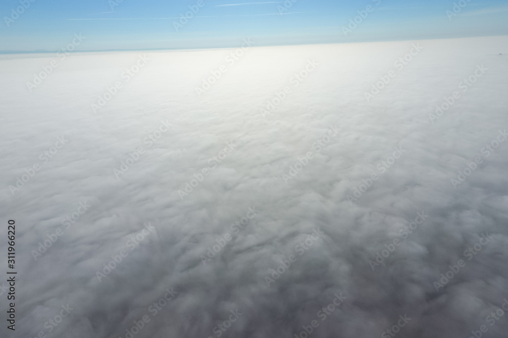 In the skies above the fog. Sunrise over the fog. Clouds near th In the skies above the fog. Sunrise over the fog. Clouds near th