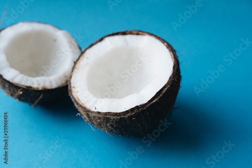 open coconut on blue background, copy space 