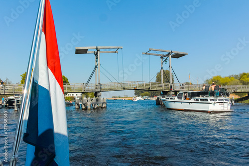 Landscape with waterways and canals of North Holland with boats, canal-side lifestyle in the Netherlands photo