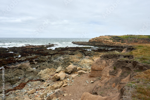 california coastline view of the rocks, sand, beach, and ocean