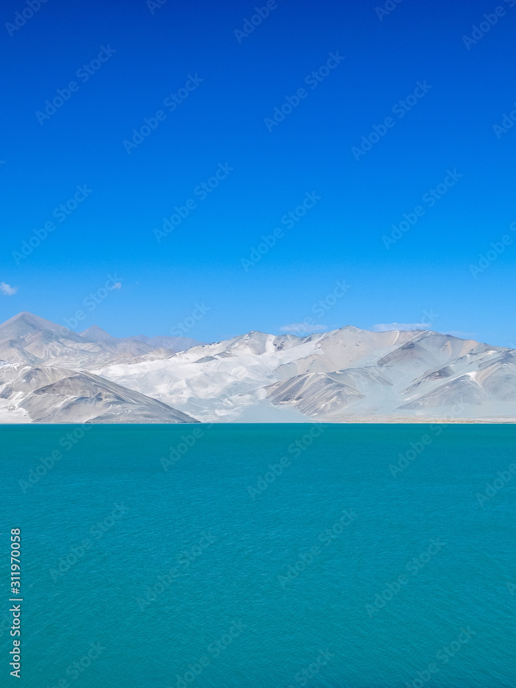 Amazing scenery of turquoise blue lake with white sand dune