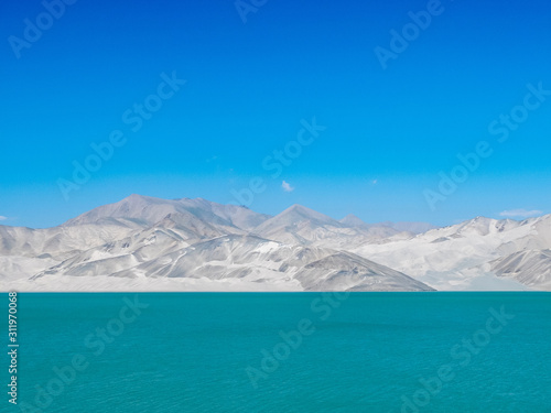 Amazing scenery of turquoise blue lake with white sand dune