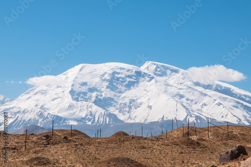 Great snow-capped mountain peak of Mount Muztag Ata on the Pamirs Plateau photo