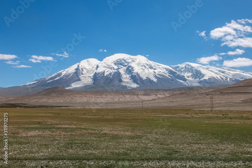 Great snow-capped mountain peak of Mount Muztag Ata on the Pamirs Plateau