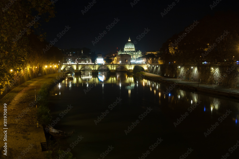 Night scene of Rome, Tevere river with basilica in background