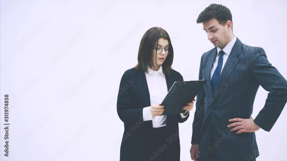 Puzzled business partners holding clipboard with sheet of paper and question mark written on it. They don't understand what it means. Puzzled business partners holding clipboard with sheet of paper and question mark written on it. They don't understand what it means.