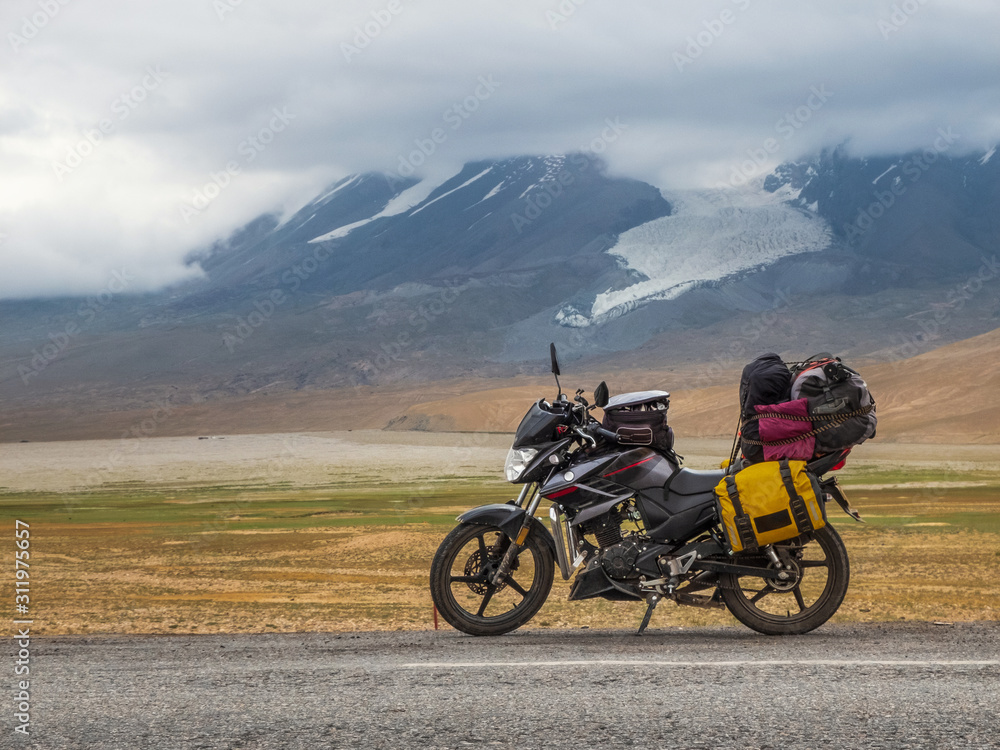 Traveling motorcycle with luggage in stormy weather
