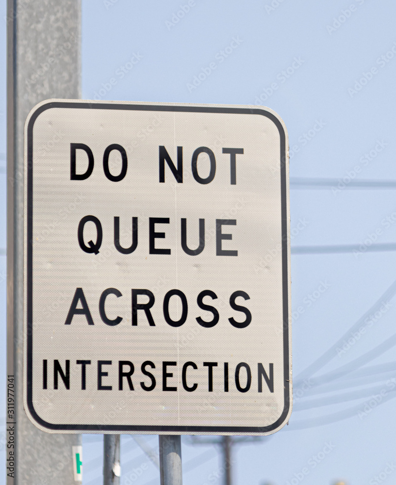 Do not queue across intersection, signposts that cannot cross in the lane.