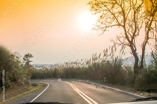 sunset on curve road in the mountain and forest, country road of Nan in north of Thailand
