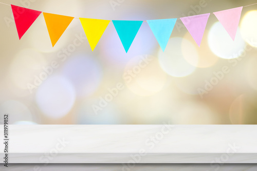 Canvas Print Colorful bunting party flags hanging onblur abstract bokeh light and white marbl