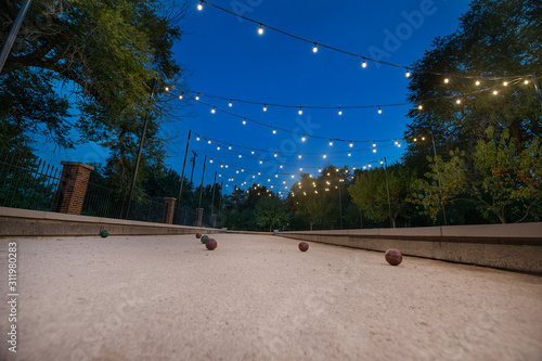 Принти на полотні Bocce Ball court with Edison lights