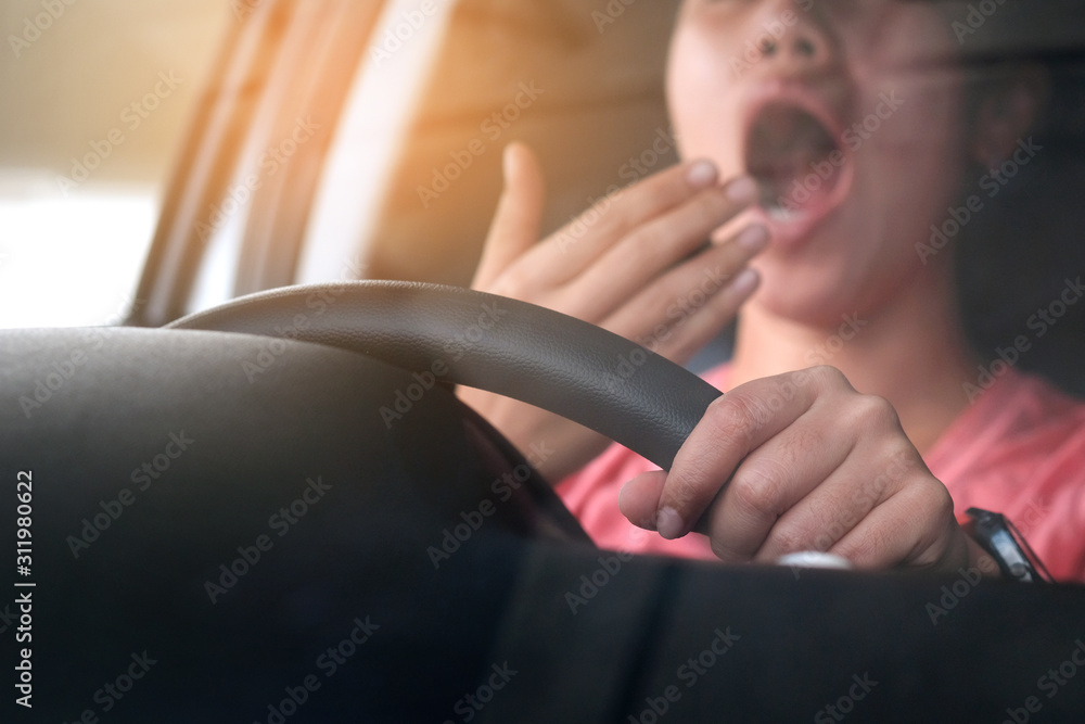 Sleepy woman While she was driving on the road. Concept of health and driving safety - obrazy, fototapety, plakaty 