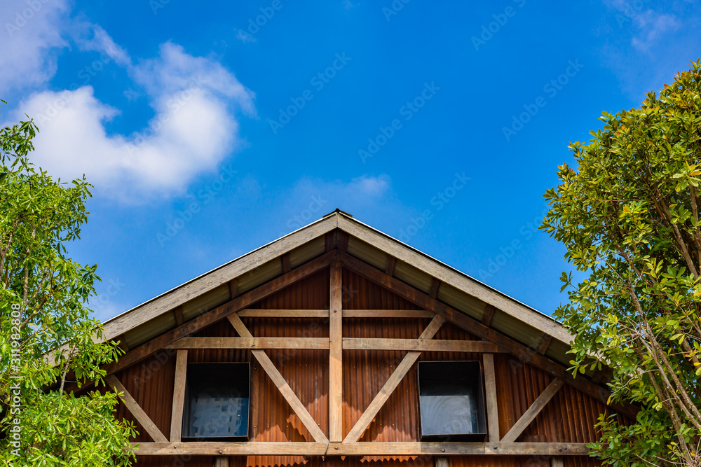 Gable of wooden houses and galvanized walls
